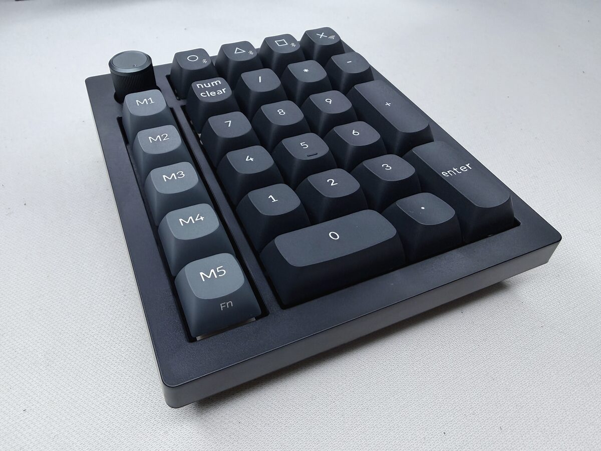 黒いテンキーを斜め上から見たところ。左端に M1 から M5 の縦列と丸いノブ、中央に数字のキー、右上に4つの小さなキーが並んでいる
